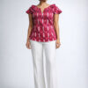 Indian Women model wearing 100% Cotton Ikat Handloom top with white pants in studio setting.