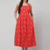 Coral woven Ikat maxi dress on model showing sleeveless neckline and flared hem