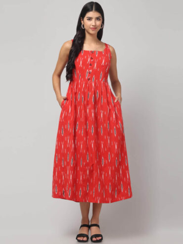 Coral woven Ikat maxi dress on model showing sleeveless neckline and flared hem