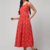 Side view of coral red sustainable handloom cotton Ikat dress with buttoned front and 2 pockets.