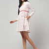 Right side view of Ikat cotton empire-waist dress with gathered flare, notch neckline and functional side 2 pockets.