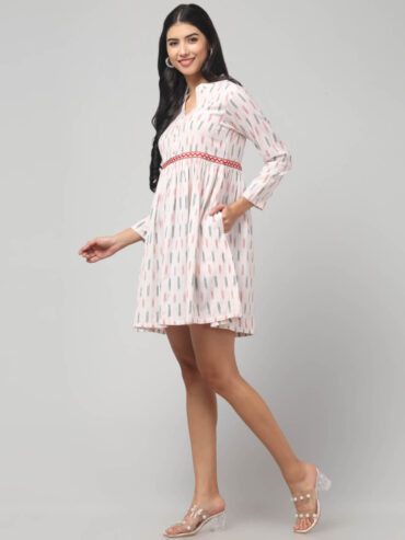 Right side view of Ikat cotton empire-waist dress with gathered flare, notch neckline and functional side 2 pockets.