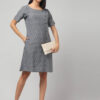 Indian model wearing slate grey color swadeshi handloom Ikath shift knee length dress with side buttons and two deep pockets.