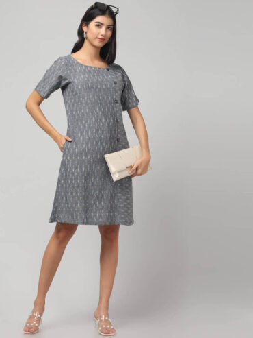 Indian model wearing slate grey color swadeshi handloom Ikath shift knee length dress with side buttons and two deep pockets.