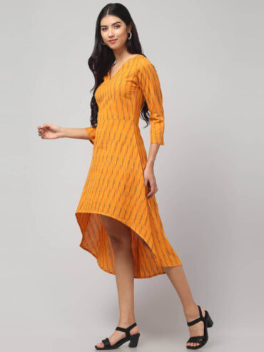 Side angle of High-low hemline detail of Yellow Ikat handloom featuring soft drape and airy movement by Abravi, New Delhi based women's clothing label.