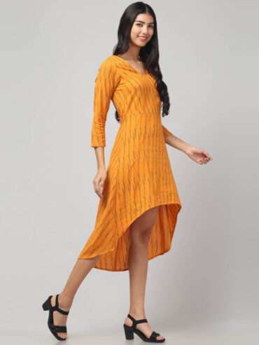Side angle of Yellow Ikat Hi-Low Dress highlighting the flowy flare, breathable Ikat cotton and high-low silhouette from Abravi Indian sustainable clothing brand by woman.