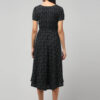 Local Indian model wearing charcoal black Ikat cotton dress for women and teenagers girls featuring puff sleeves and airy flared fit