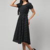 Indian female model wearing charcoal black eco friendly handloom Ekat pure cotton midi dress with puff sleeves