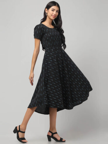 Indian model wearing charcoal black cotton hi-low dress for women and girls with short puff sleeves and empire waist by Abravi India.
