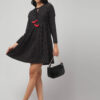Black Ikat Fit and Flare Frock knee length dress with red tassels and two pockets, worn by a Indian model front-facing.