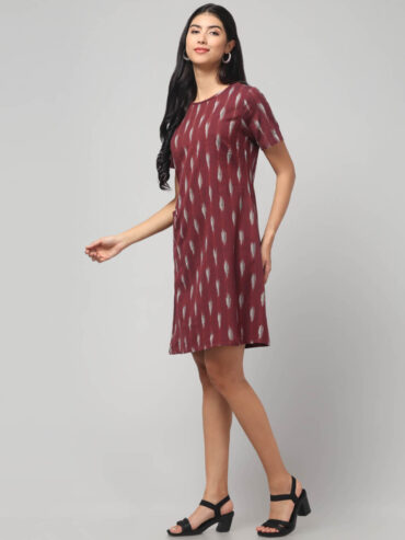 Indian model showcasing rosewood Ikkat handloom cotton fabric pattern on women dress
