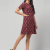 Side view of rosewood maroon Ekat Cotton shift dress showcasing handloom texture.