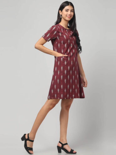 Side view of rosewood maroon Ekat Cotton shift dress showcasing handloom texture.