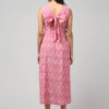 Back view of carnation pink sustainable Ikat cotton dress with adorable back-tie bow and pockets by Abravi