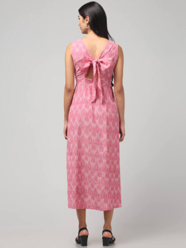 Back view of carnation pink sustainable Ikat cotton dress with adorable back-tie bow and pockets by Abravi