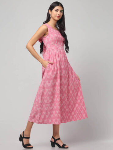 Left side view of Abravi Carnation Pink handloom cotton Ikat dress with back bow -tie details.