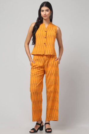 the front view of Indian model showing the Sunny Zest in chorme yellow shade Ikath co-ord set with 2 pockets detailing.