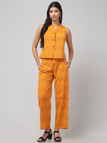 the front view of Indian model showing the Sunny Zest in chorme yellow shade Ikath co-ord set with 2 pockets detailing.