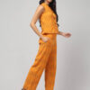 Indian model wearing the sunny zest chorme yellow Ikath Cotton co-ord set with two side pockets for women and gilrs by Abravi India