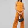 Indian model wearing handmade chorme yellow handloom Ikat pure cotton sleeveless co-ord set with relaxed fit pants.