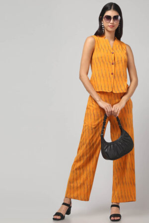 Indian model wearing handmade chorme yellow handloom Ikat pure cotton sleeveless co-ord set with relaxed fit pants.