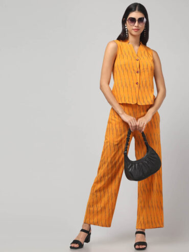 Indian model wearing handmade chorme yellow handloom Ikat pure cotton sleeveless co-ord set with relaxed fit pants.