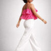 Side view of an Indian female model walking in a pink Ikat Handloom Cotton crop top and white Ikat pants.