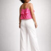 Back view of a pink Ikat handloom cotton crop top and white pants on an Indian female model, showing rear fit and detailing by Abravi India Handlooms.