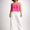 Indian female model wearing a pink Ikat Handloom Cotton crop top with white pants in a minimalist studio setting.