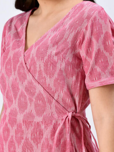 close up of pink handloom Ikat wrap dress for Indian women, handcrafted sustainable ethnic wear.